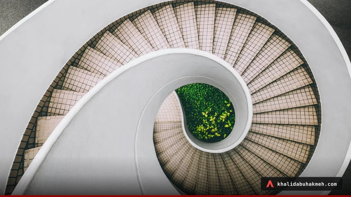 White and brown concrete spiral stairs. Photo by Dan Freeman on Unsplash.